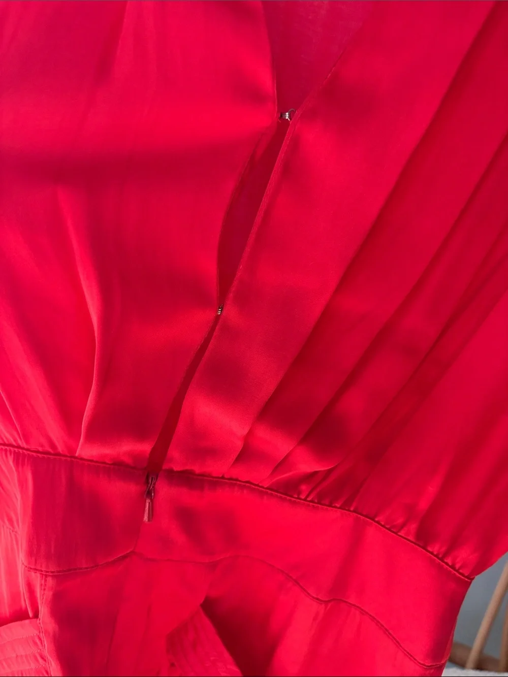 Beautiful Bebe satin vibrant red/orange romper with gold accents.